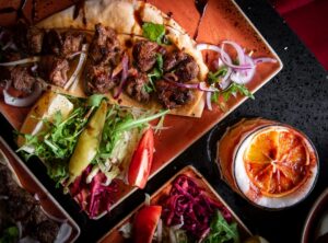 Grilled meat wrap with fresh salad and citrus cocktail at Maya Lounge