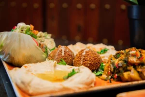 Falafel platter with hummus, pita bread and mixed vegetables at Maya Lounge