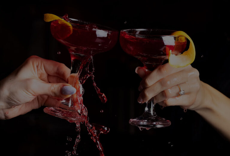 Guests toasting with red cocktail glasses at Maya Lounge, a shisha lounge near Finchley