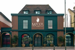 Interior of Maya Lounge, a shisha lounge near Southgate, with illuminated MAYA sign and lounge seating